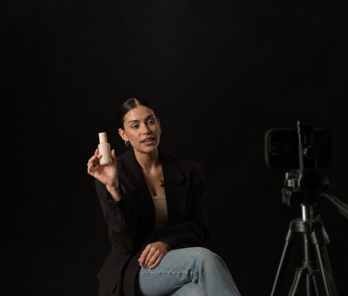 An AI-generated presenter filmed against a dark backdrop.
