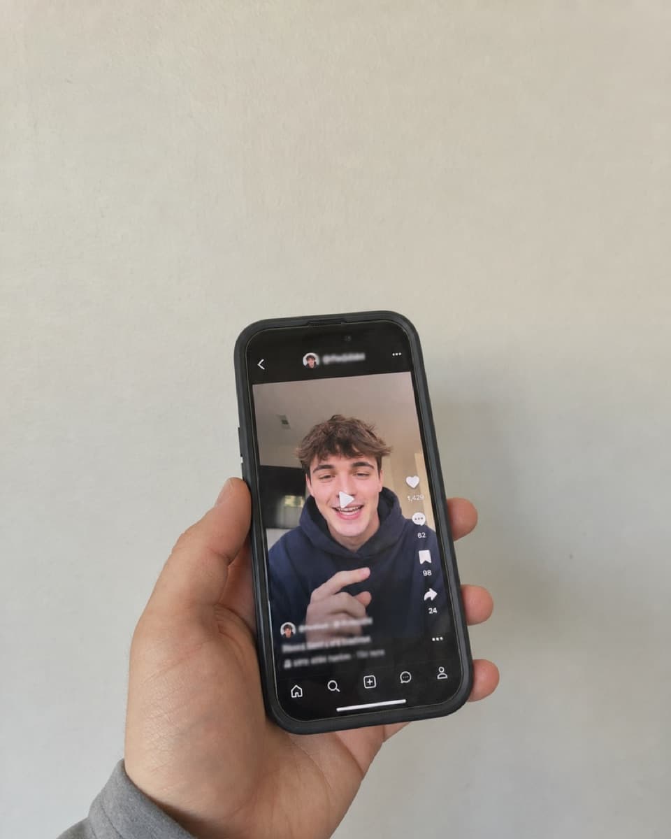 A phone showing the clip as an organic post on a creator profile.