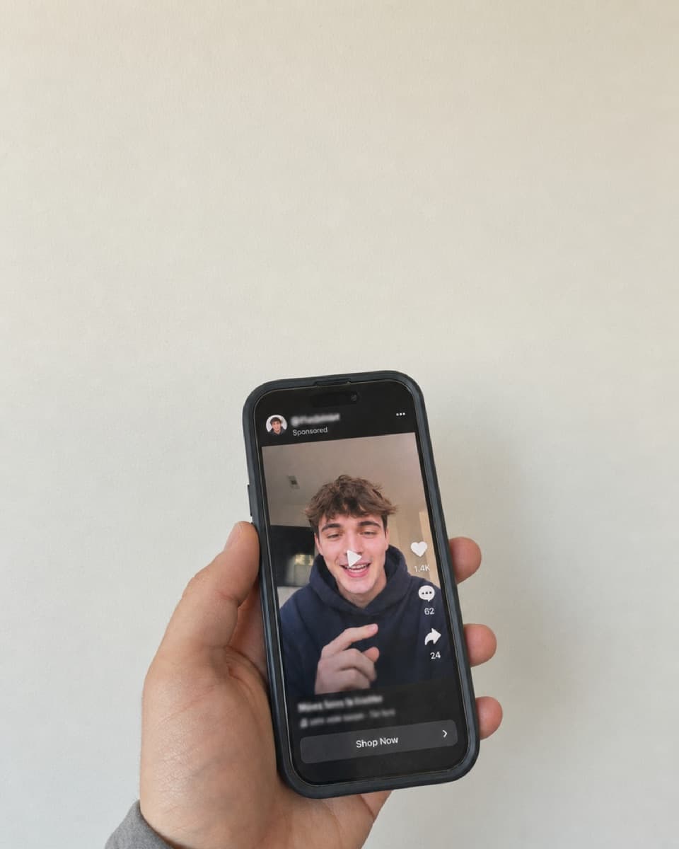 A phone showing the same clip running as a sponsored ad.