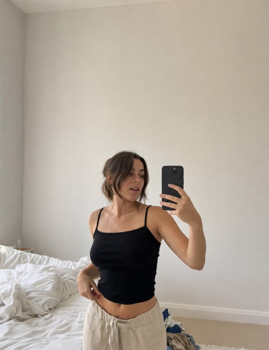 A creator filming a try-on in her own mirror.