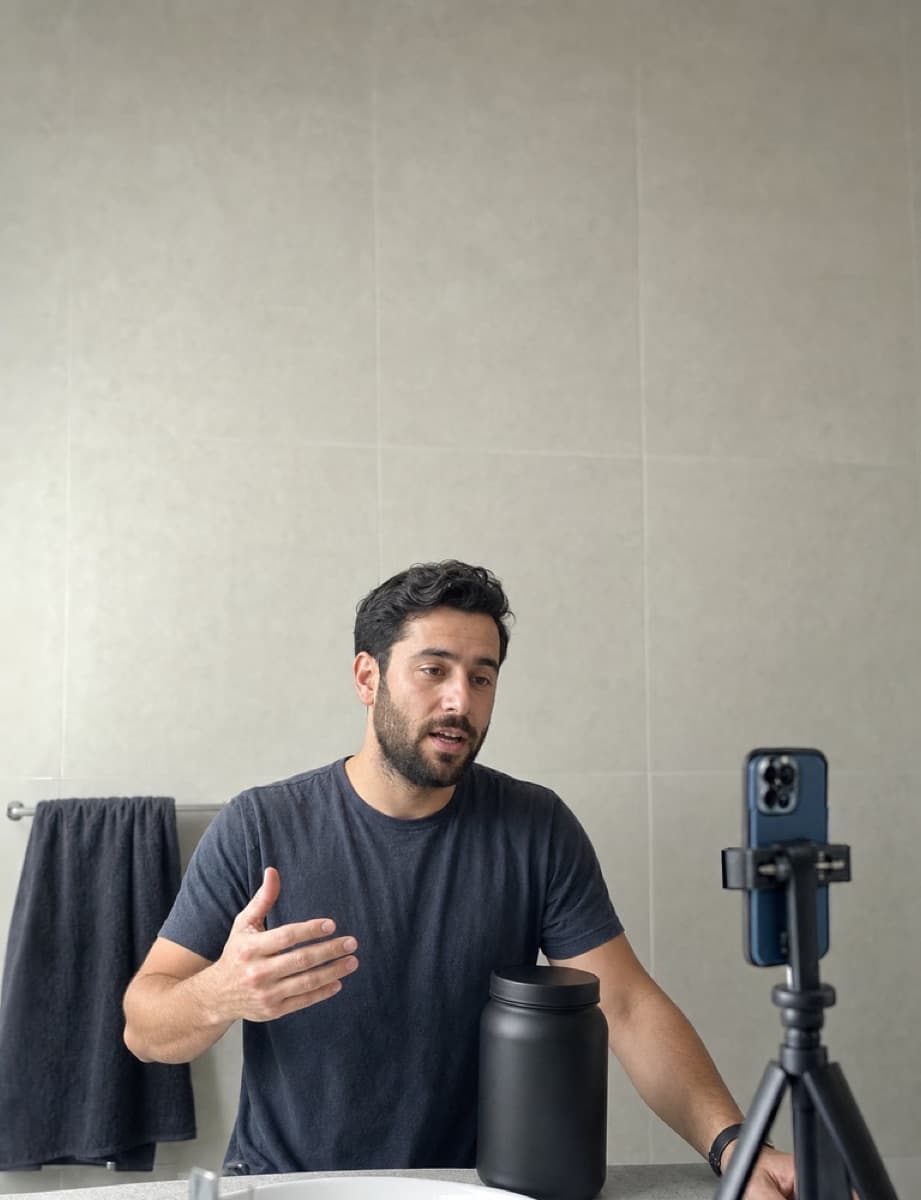 A creator filming a daily supplement routine at home.
